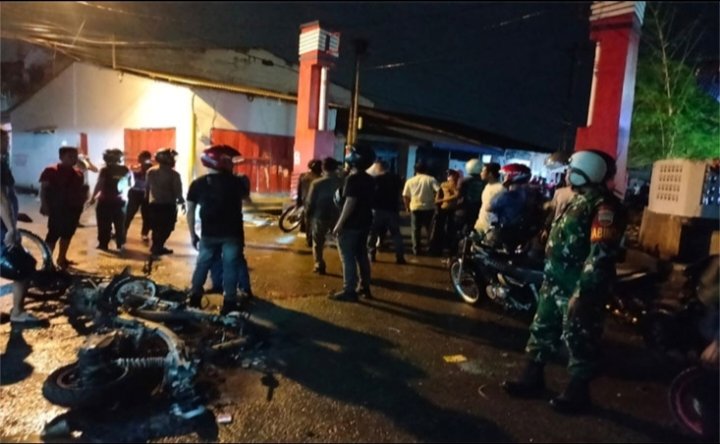 Situasi sekitar TKP dan dua unit sepeda motor milik Polisi yang dibakar orang tak dikenal. 